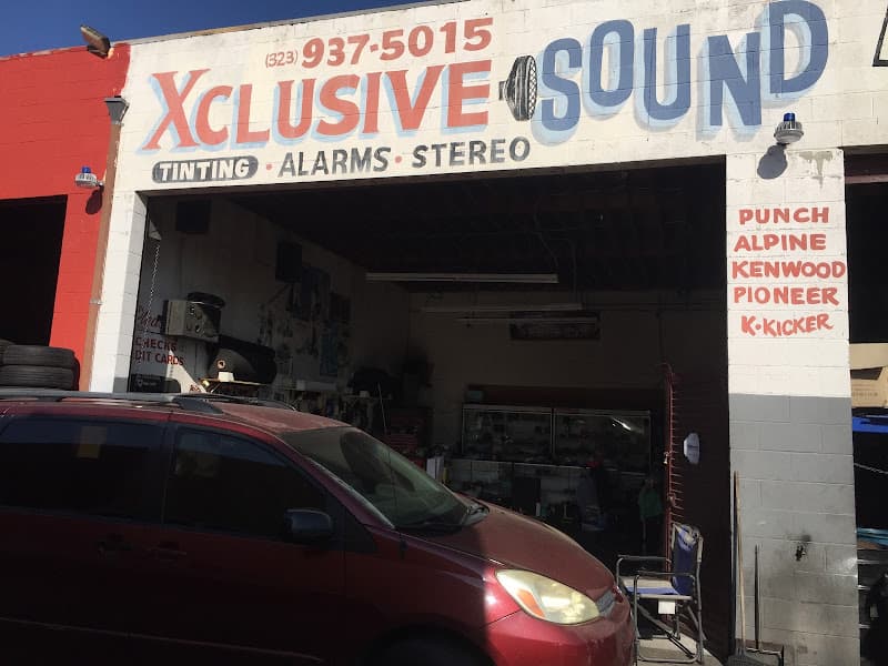 Shop front with a painted sign for tinting, alarms and stereo at Exclusive Sound in Los Angeles, California