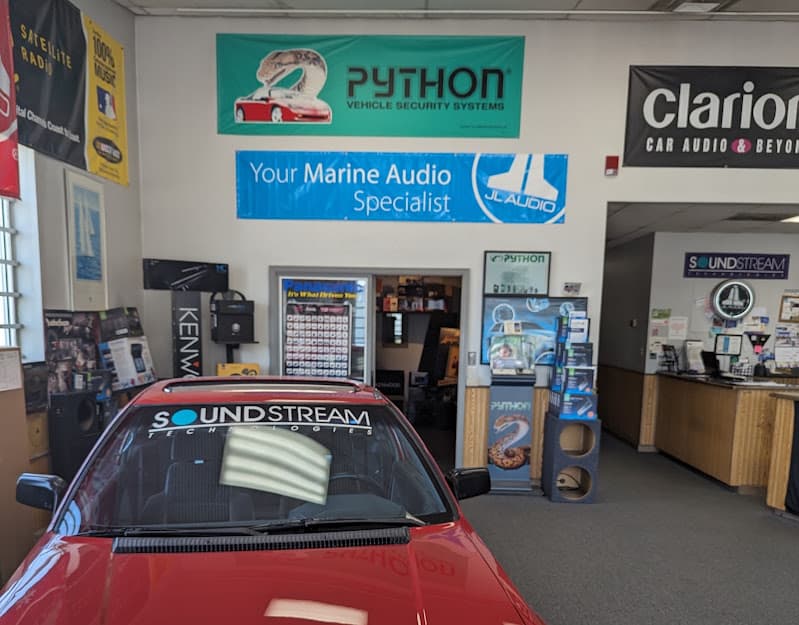 Showroom with Python and Clarion signs above a display counter at Accutek Electronics in Merrillville, Indiana