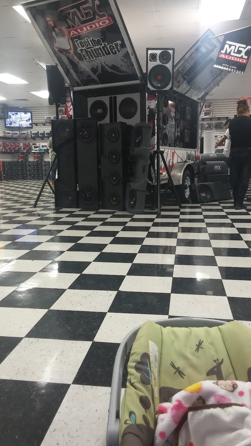 MTX Audio display with speaker stacks on checkered floor at JM KUZTOMZ in Nevada, Texas