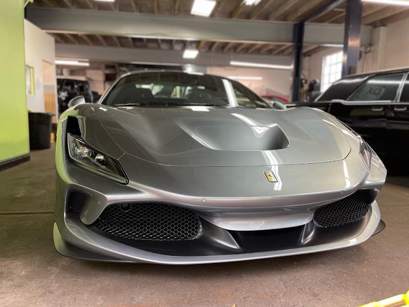 Gray Ferrari nose with front splitter in a shop bay at OxAudio in Cheltenham, Pennsylvania