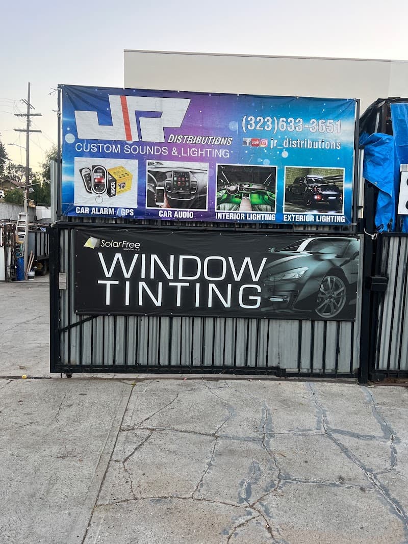 Blue banner listing car audio, alarms and lighting services at JR DISTRIBUTIONS in Los Angeles, California
