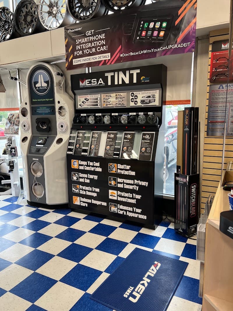 Tint display beside a white JL Audio speaker tower at Imagine Audio in Cherry Hill Township, New Jersey