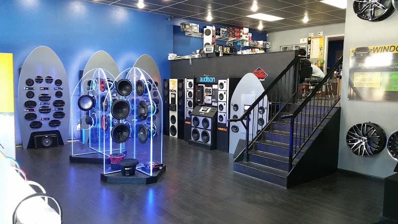 Showroom with speaker displays and wheels on wall at Santa Clarita Auto Sound in Santa Clarita, California