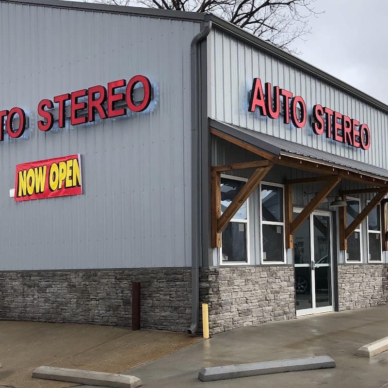 Storefront with red letter signs and a stone base at Auto Stereo in Clarksville, Tennessee