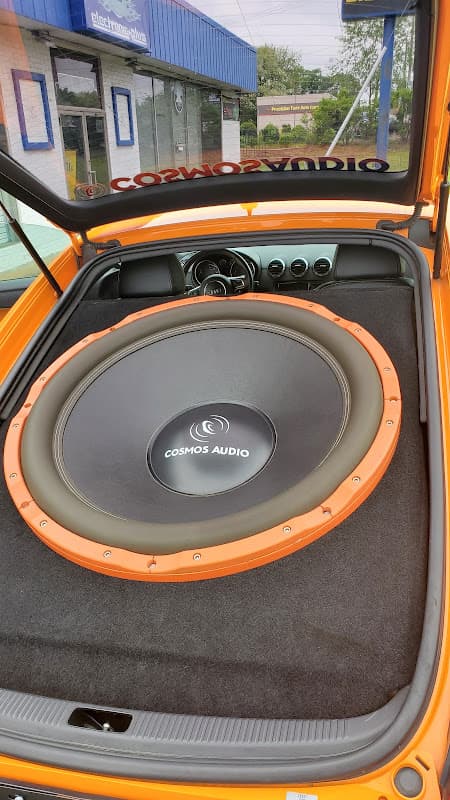 Orange car trunk with Cosmos Audio subwoofer at Cosmos Audio in Manassas, Virginia