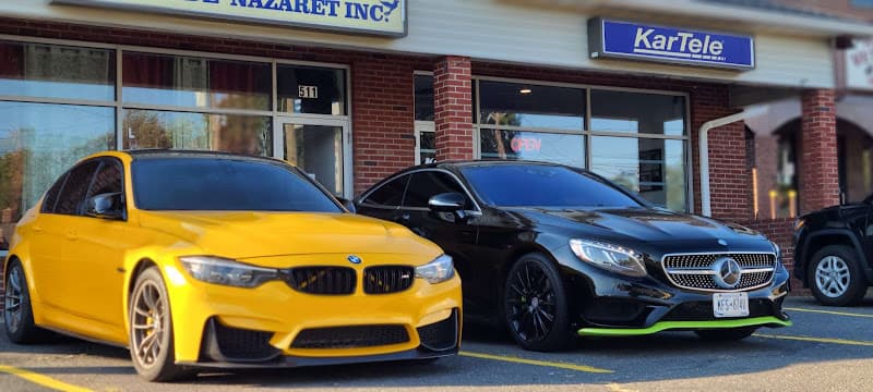 Yellow BMW and black Mercedes parked outside a storefront at KarTele Mobile Electronics in Waterbury, Connecticut