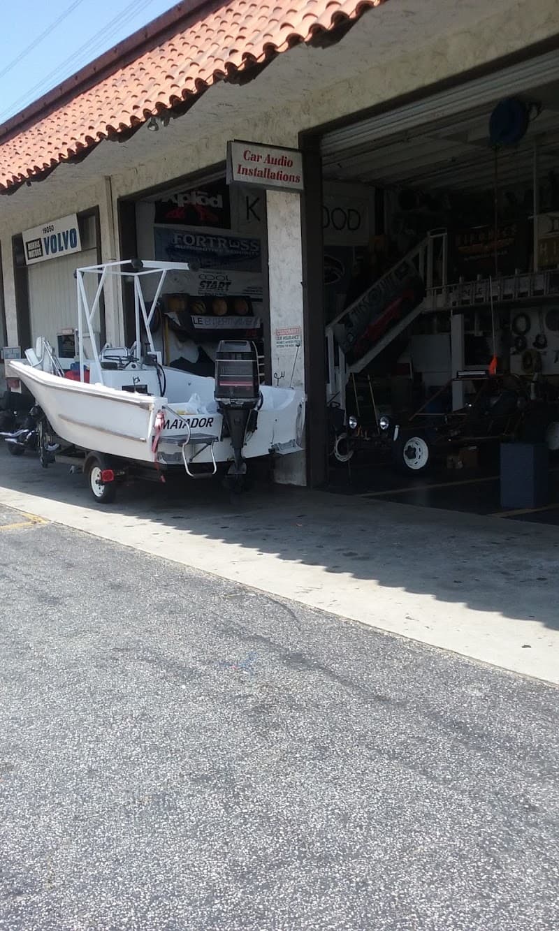 White boat on trailer outside shop at Bob's Car Audio & Electronics Incorporated in Torrance, California
