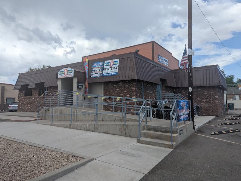 Brick and metal storefront with Good Deal Thrift Store signs at R & R Discount Car Audio in Grand Junction, Colorado