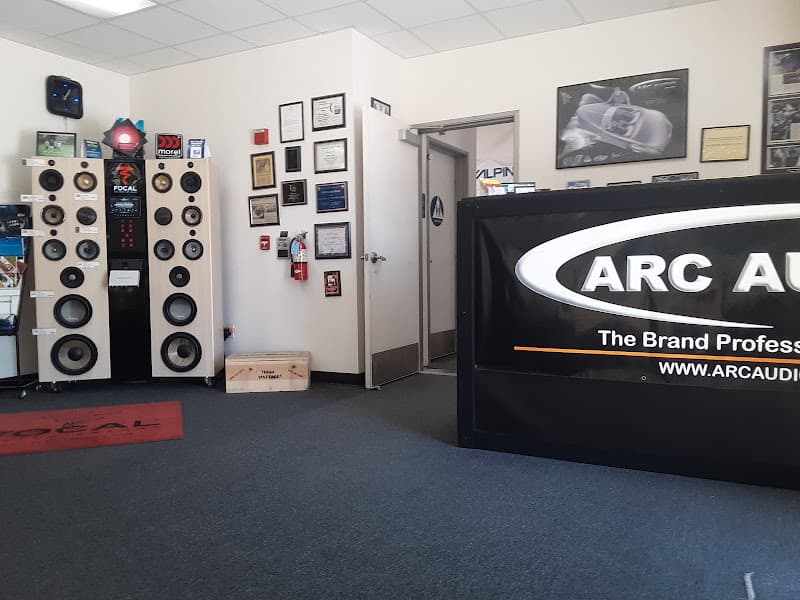 Showroom with Focal tower speakers and an ARC Audio sign at Tune Time Stereo & Alarm in Redlands, California