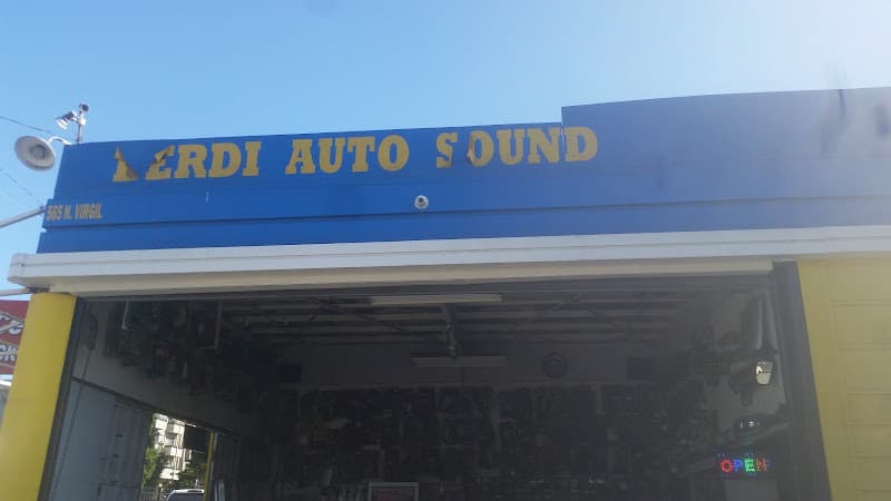 Blue sign with yellow letters over an open garage bay at Berdi Auto Sound in Los Angeles, California