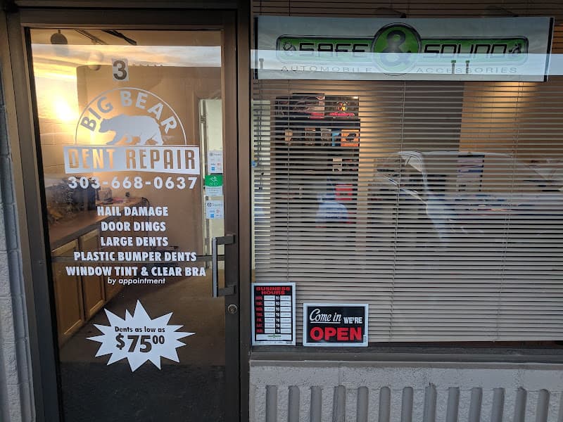 Storefront with dent repair door decals and window sign at Safe and Sound Auto Accessories in Longmont, Colorado