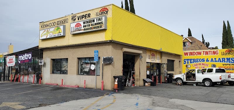 Yellow storefront with Kenwood, Kicker and Viper signs at California Installs in Los Angeles, California