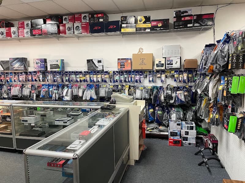 Glass display cases below a pegboard of accessories at U Mart Car Audio in Bolingbrook, Illinois