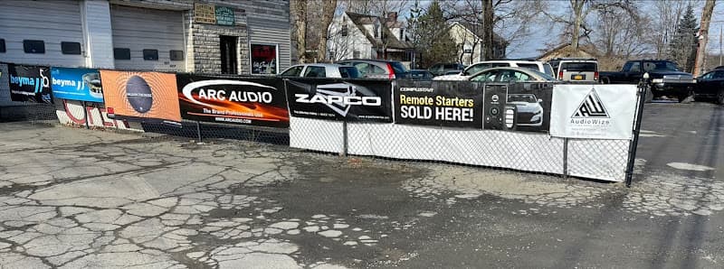 Fence with ARC Audio, Zapco and AudioWize banners at AUDIOWIZE in Middletown, New York