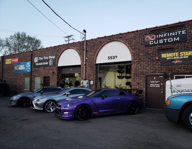 Brick shop front with purple sports coupe and remote start sign at Infinite Custom in Oak Lawn, Illinois