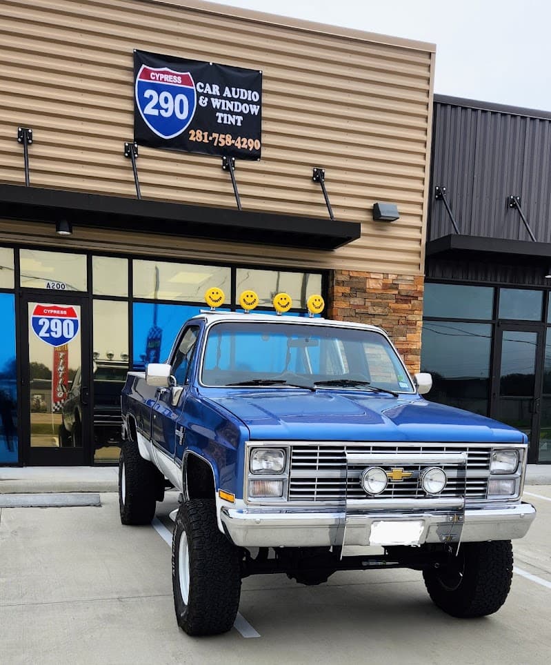 Blue Chevrolet pickup truck parked outside a storefront at 290 Car Audio in Cypress, Texas