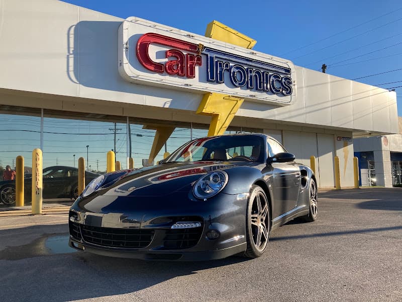 Black sports coupe parked in front of a storefront at CarTronics in Madison, Tennessee
