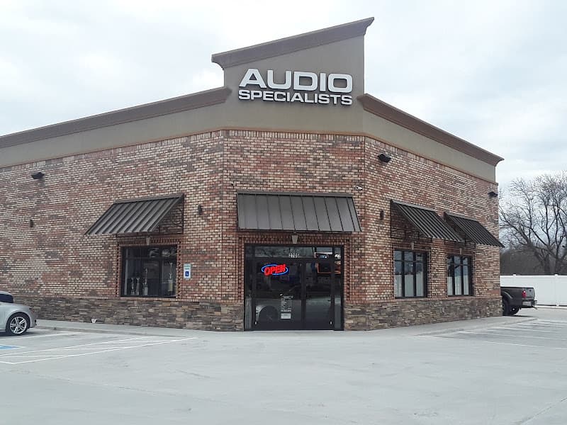 Brick storefront with raised sign and glass entrance door at Audio Specialists in Clarksville, Tennessee