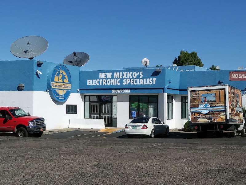 Blue building with sign and parked cars at Paradise Village the Electronic Specialists in Albuquerque, New Mexico