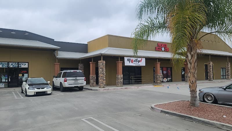 Strip mall storefront with a palm tree and parked cars at Modfyd Motorsports in Hemet, California