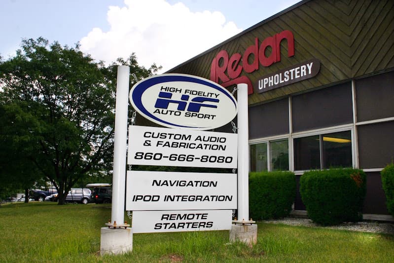 Roadside sign listing custom audio and remote starters at High Fidelity Auto Sport in Newington, Connecticut