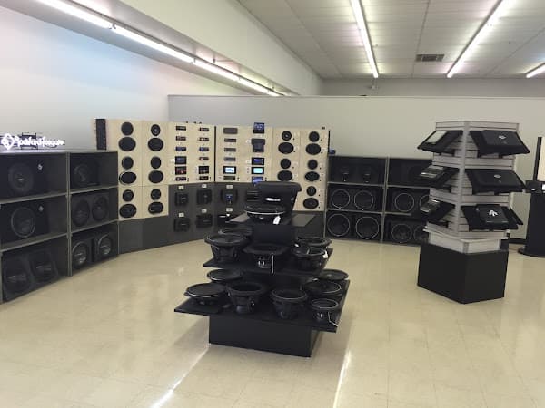 Showroom with speaker enclosures and subwoofers on display at Car Toyz in Topeka, Kansas
