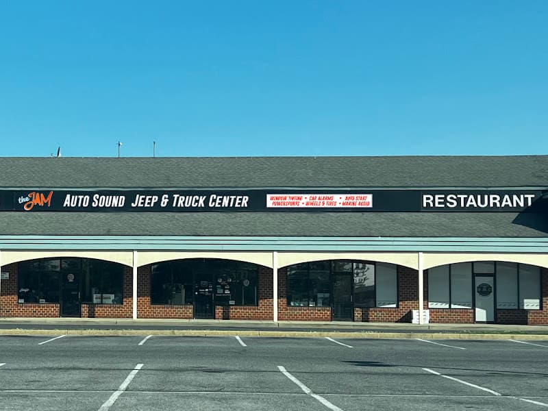 Storefront with black sign reading Auto Sound Jeep and Truck Center at Audio Jam Inc in Bear, Delaware
