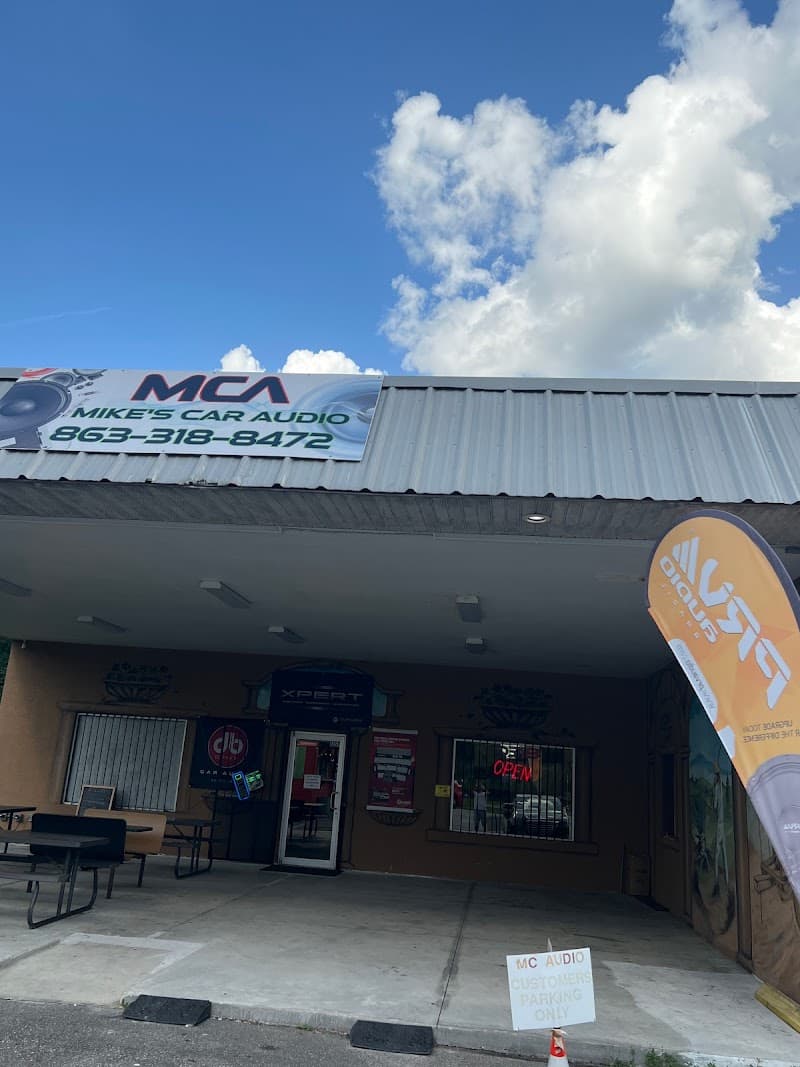 Storefront with a rooftop sign and glass entry door at MC Audio in Winter Haven, Florida