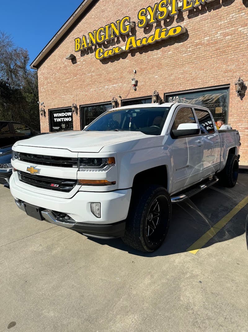 White Chevrolet pickup with black wheels at Banging Systems Car Audio, INC. in Fayetteville, North Carolina