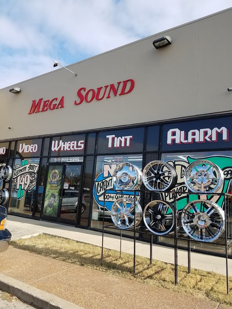 Storefront with red sign, window ads and chrome wheels out front at Mega Sound in Nashville, Tennessee