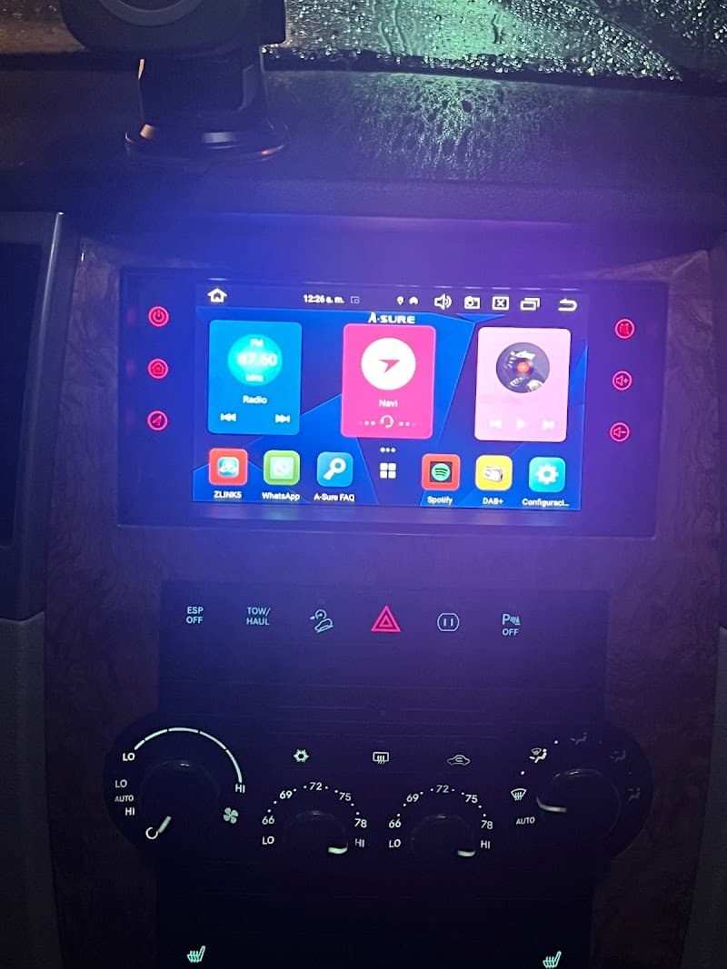 Touchscreen in dark cabin showing radio and app icons at Spanking Clean Auto Sound and Security in Norwalk, Connecticut