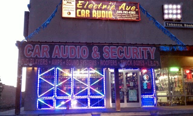 Storefront with a lit Car Audio and Security sign at Electric Avenue in Albuquerque, New Mexico