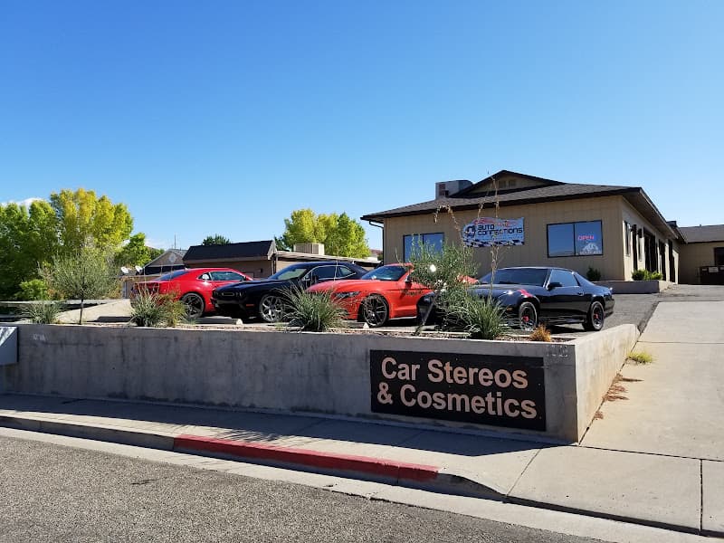 Shop exterior with a Car Stereos & Cosmetics sign and parked cars at JL Auto Connections in St. George, Utah