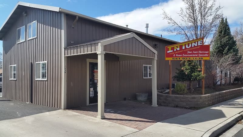 Brown building with covered entrance and red InTune sign at InTune in Redmond, Oregon