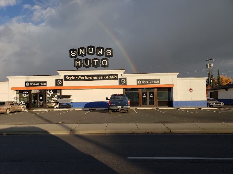 Storefront under a rainbow with a pickup parked out front at Snow's Auto in Spokane, Washington
