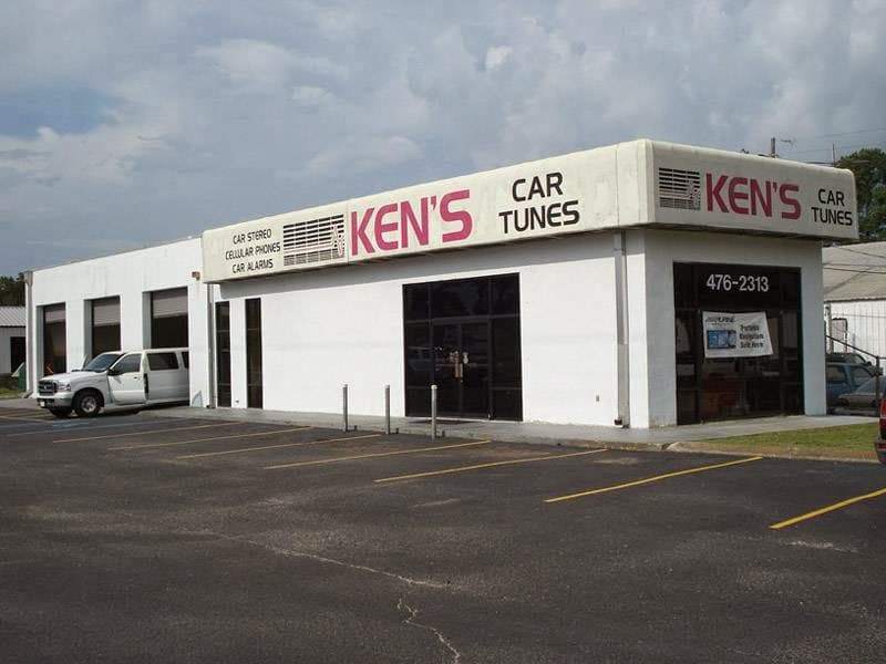 White storefront with red KEN'S CAR TUNES sign and a white van at Ken's Car-Tunes and Marine in Mobile, Alabama