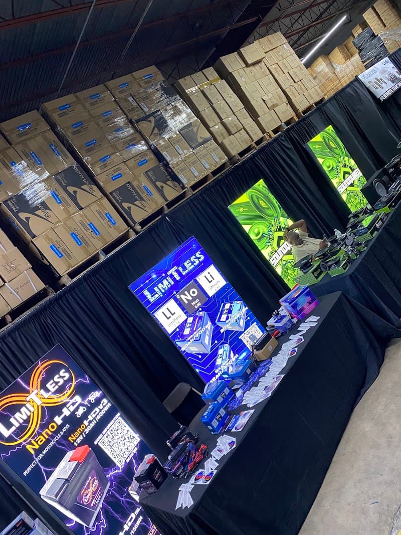 Trade show booth with Limitless battery displays and black drapes at SSR Distributors in Houston, Texas