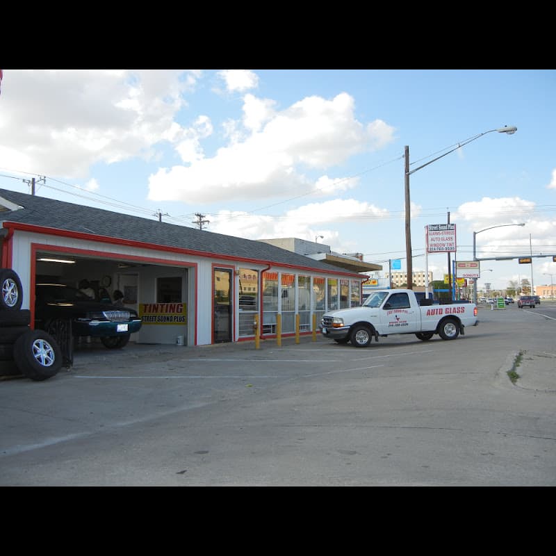 Storefront with a tinting bay and a white pickup truck parked outside at Street Sound Plus in Garland, Texas