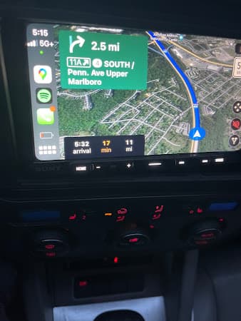 Sony touchscreen showing a navigation turn prompt above climate controls at Crazy Car Audio in College Park, Maryland