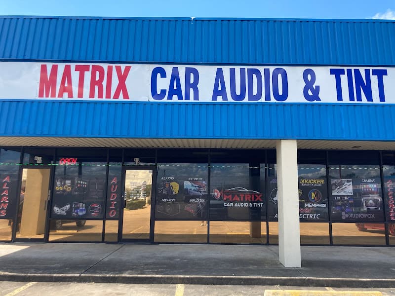 Blue storefront with glass windows and a large sign at Matrix Car Audio and Tint in Houston, Texas