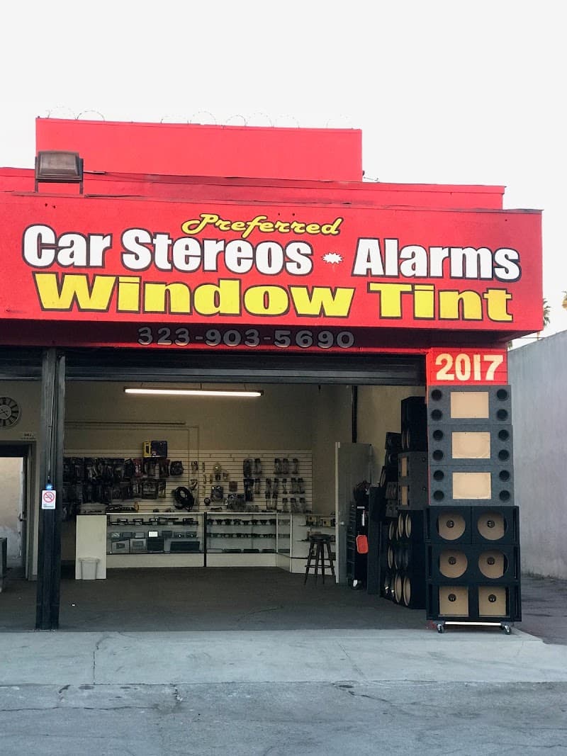 Storefront with open bay and stacked speaker cabinets outside at Preferred Stereo & Window Tint in Los Angeles, California