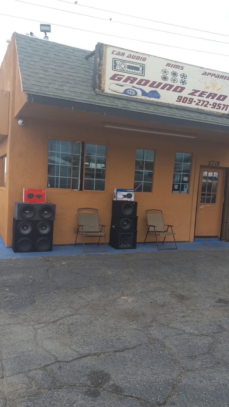 Orange storefront with speaker stacks and two chairs outside at Ground Zero Customs in Twentynine Palms, California
