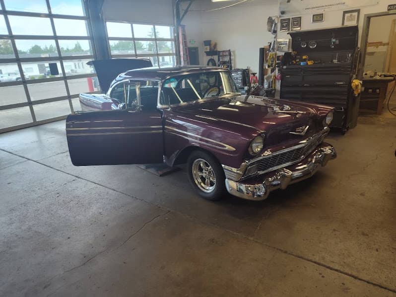 Maroon classic sedan with open driver door in shop bay at The Stereo Store! in Albany, Oregon