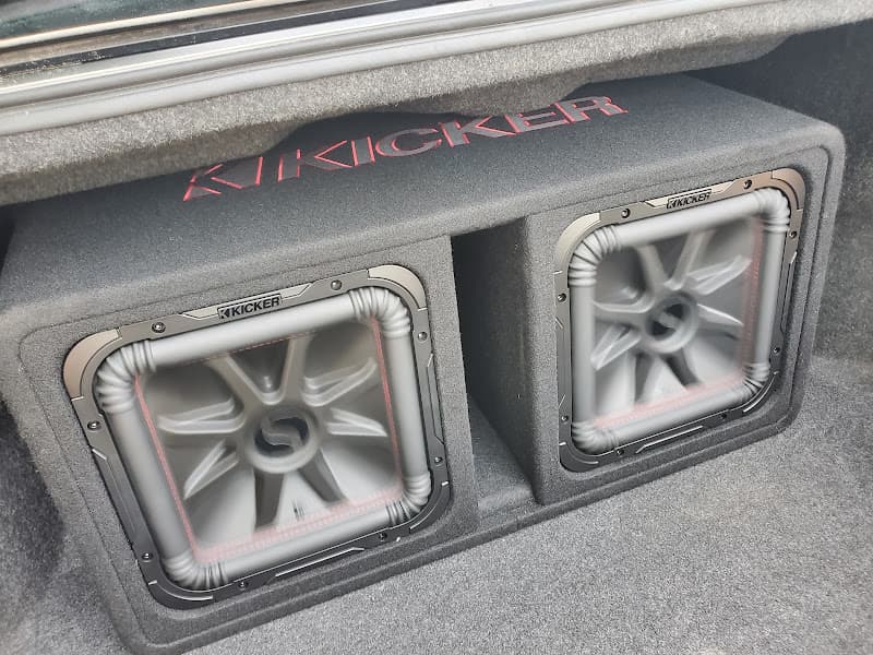 Two Kicker subwoofers in a trunk enclosure at Custom Sounds & Tint - Edmond OK in Edmond, Oklahoma