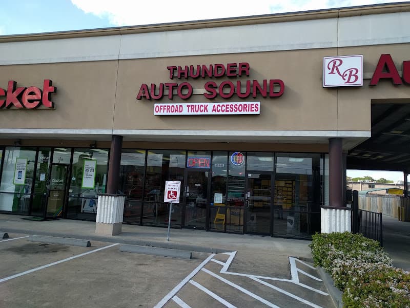 Storefront with red sign and glass doors at Thunder Auto Sound in Houston, Texas