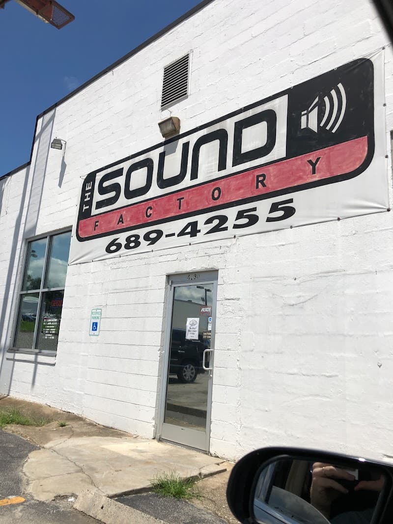 White brick building with a large banner and phone number at The Sound Factory in Knoxville, Tennessee