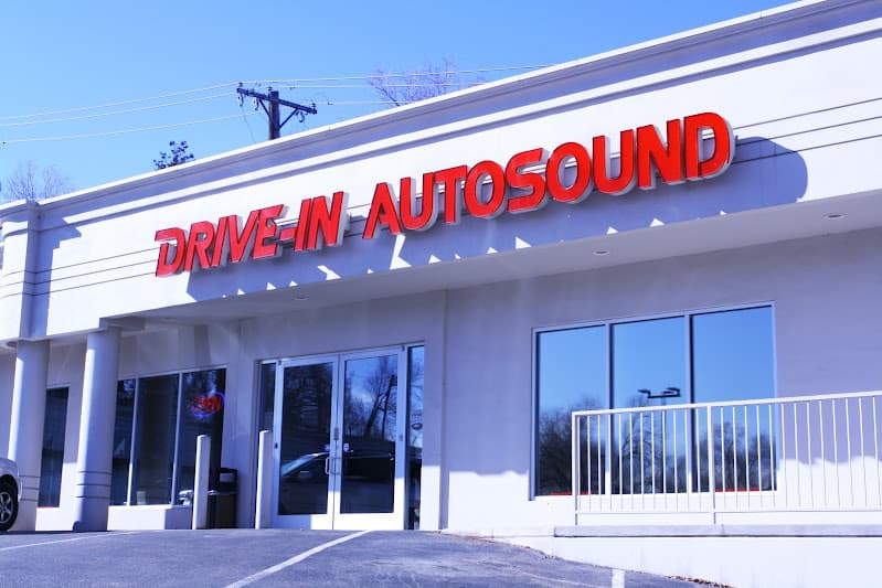 White storefront with red lettering and glass doors at Drive-In Autosound & Window Tint in Colorado Springs, Colorado