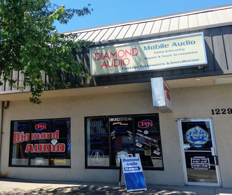 Storefront with Diamond Audio sign and window signs at Diamond Audio in Medford, Oregon