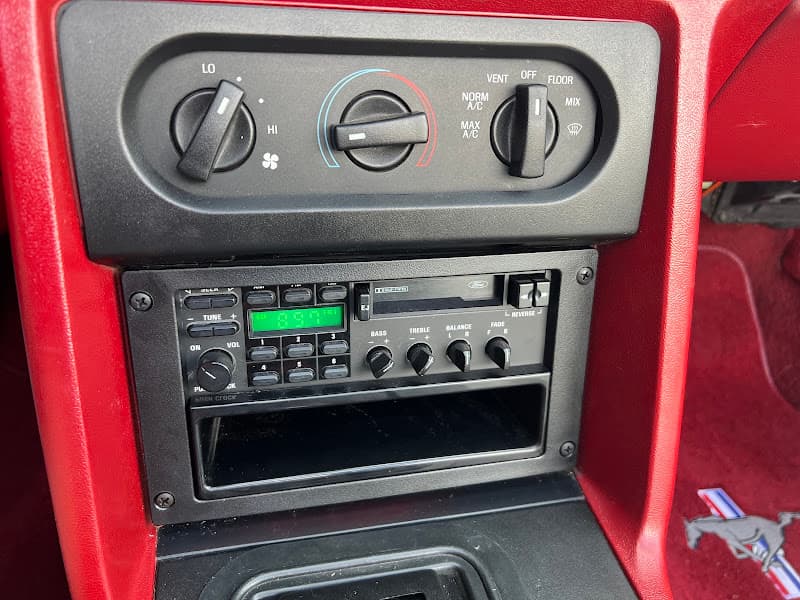 Dashboard with climate controls and a car stereo head unit below at Al's Creative Autosound in Pueblo, Colorado