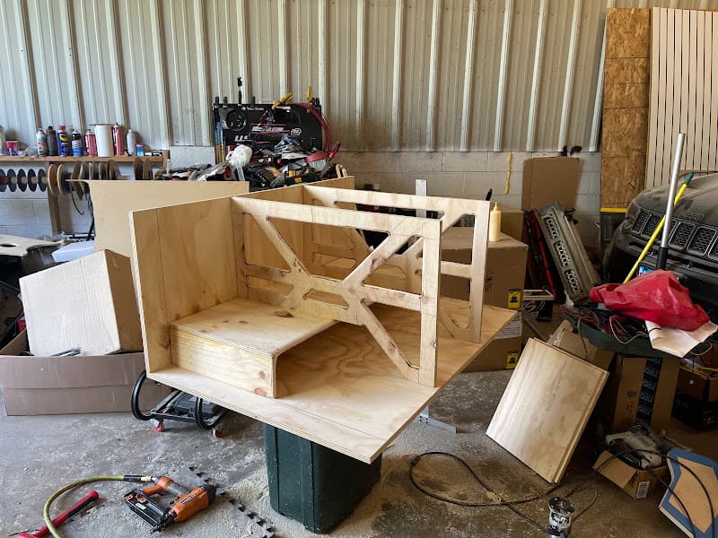 Wooden subwoofer enclosure under construction in a garage at Just Another Sound Shop in Lansing, Illinois